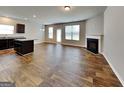Open living space with hardwood floors, fireplace, and access to the kitchen at 1392 Worcester Trl, Mcdonough, GA 30253