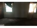 Bedroom with two windows, carpet, and a door at 2017 Pine Cone Sw Dr, Atlanta, GA 30331