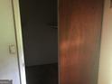 Hallway with a view of a dark room and a wood sliding door at 2017 Pine Cone Sw Dr, Atlanta, GA 30331