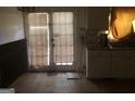 Kitchen with tile floor, white cabinets, and a door leading to the outside at 2017 Pine Cone Sw Dr, Atlanta, GA 30331