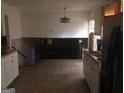 Kitchen with white cabinets and view to second room at 2017 Pine Cone Sw Dr, Atlanta, GA 30331
