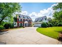 Lovely brick and siding two-story home with attached garage and a circular driveway and well-manicured lawn at 1745 Stripling Chapel Rd, Carrollton, GA 30116