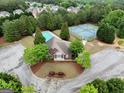 Aerial view of community center with pool, tennis courts, and lush landscaping at 1144 Simonton Hill Ct, Lawrenceville, GA 30045