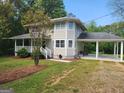 Charming home featuring an attached carport and well-manicured landscaping at 3581 S Hwy 100, Bowdon, GA 30108