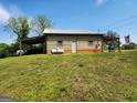 Versatile outbuilding with covered parking and an American flag display at 3581 S Hwy 100, Bowdon, GA 30108