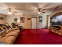 Open living room featuring a ceiling fan and access to white exterior door at 1170 Peeksville Rd, Locust Grove, GA 30248
