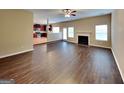Spacious living room with fireplace, hardwood floors, and access to kitchen at 4140 Butternut Pl, South Fulton, GA 30349