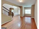 Bright living room featuring hardwood floors, arched doorways, and natural light at 4140 Butternut Pl, South Fulton, GA 30349