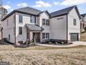 A well-maintained, two-story home with a white brick facade and a neatly landscaped front yard at 209 Langshire Dr, Mcdonough, GA 30253