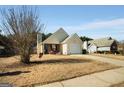 View of the home and lawn on a sunny day at 351 Autumn Lake Dr, Mcdonough, GA 30253