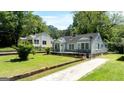 Beautiful home with a manicured lawn and a cozy front porch, perfect for enjoying the outdoors at 1774 Campbellton Rd, Atlanta, GA 30311