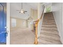 Open-concept living space featuring stairs, fireplace, and natural light from large windows at 402 Sherrels Frd, Peachtree City, GA 30269