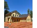 Exterior view of a new two-story home under construction, featuring light yellow siding and a simple roof at 107 Oak Rd, Locust Grove, GA 30248