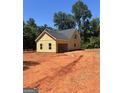 Detached garage with light yellow siding, complemented by a simple roof and surrounded by a cleared lot at 107 Oak Rd, Locust Grove, GA 30248