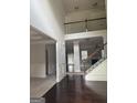 Spacious foyer boasts soaring ceilings, elegant staircase with dark hardwood flooring, and bright, neutral paint at 1124 Pebble Creek Ln, Locust Grove, GA 30248