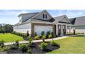 Beautiful home featuring brick, manicured lawn, and 2-car garage at 604 Parnassus Rd # 05, Locust Grove, GA 30248
