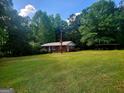 Charming single-story brick home with a well-maintained lawn and wooded backdrop at 309 Cornish Mountain Rd, Covington, GA 30014