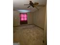 Bedroom with paneled walls, ceiling fan, and window for natural light at 4298 Brookside Dr, Forest Park, GA 30297