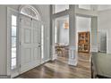 Bright foyer with wood floors leading to dining area and a large arched window at 215 Murphy Creek Ln, Fayetteville, GA 30215