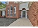 Inviting front entrance with a black door, a wreath, and arched windows at 215 Murphy Creek Ln, Fayetteville, GA 30215