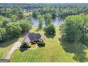 Expansive property with a charming red brick home overlooking a serene lake at 70 Lake Charles Xing, Covington, GA 30016