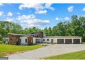 Expansive modern home with a three car garage and large driveway in a lush, green setting at 159 Sims Rd, Tyrone, GA 30290