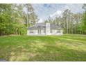 Expansive backyard with well-maintained lawn, perfect for outdoor activities and relaxation surrounded by mature trees at 2180 Briarwood Ct, Villa Rica, GA 30180