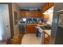 Kitchen with oak cabinets, laminate countertops and stainless steel dishwasher at 3191 Kingswood Gln, Decatur, GA 30034