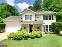 Charming two-story home featuring a manicured lawn, a welcoming porch, and lush greenery, offering inviting curb appeal at 508 Caxton Ct, Peachtree City, GA 30269