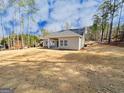 Expansive backyard with a view of the home's exterior and surrounding landscape at 5096 Cumberland Ct # 96, Villa Rica, GA 30180