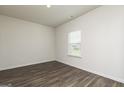 Bright bedroom with hardwood floors and a window providing natural light at 260 Oliver Dr, Locust Grove, GA 30248