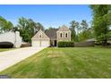 Two-story home with a well-manicured lawn and a two-car garage on a spacious lot at 150 Rockspray Rdg, Peachtree City, GA 30269