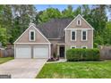 Charming two-story home featuring a well-manicured lawn and a two-car garage at 150 Rockspray Rdg, Peachtree City, GA 30269