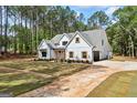 Beautifully crafted home with board and batten siding, contrasting trim, a well-manicured lawn, and private driveway at 4731 H D Atha Rd, Covington, GA 30014