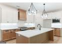 Bright kitchen featuring custom cabinetry, a center island, and stainless steel appliances at 4731 H D Atha Rd, Covington, GA 30014