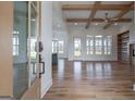 Open-concept living room with hardwood floors, wood beams, and plenty of natural light at 4751 H D Atha Rd, Covington, GA 30014