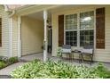 Inviting front porch with seating, charming details, and a glimpse of a well-maintained garden at 205 N Strathmore Dr, Sharpsburg, GA 30277