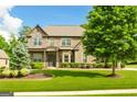 Stunning brick home with a manicured lawn, elegant landscaping, and a welcoming entrance in a suburban setting at 2589 Lake Erma Dr, Hampton, GA 30228