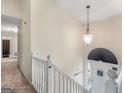 Bright foyer showcasing a staircase with white railings, a pendant light, and a front door at 140 Joshua St, Palmetto, GA 30268