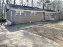 Brick home featuring a side entrance and a well maintained yard at 599 Cherry Ln, Jonesboro, GA 30238