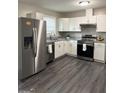 Bright kitchen featuring stainless steel appliances and white cabinets at 599 Cherry Ln, Jonesboro, GA 30238