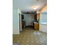 Kitchen area with oak cabinets, window, and linoleum floors at 60 Doe Run Dr, Sharpsburg, GA 30277