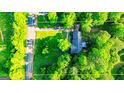 Overhead view of a home nestled amongst lush trees with a well-manicured lawn at 530 Austin Dr, Mcdonough, GA 30252
