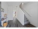 Inviting foyer with hardwood floors, staircase and white walls leading to living area at 109 Feeney Lane, Villa Rica, GA 30180