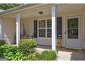 Charming front porch with seating area, decorative wreath, and a welcoming entrance at 254 Roberts Trl, Locust Grove, GA 30248
