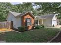 Image of a home showcasing the side and rear exterior, featuring a combination of vinyl siding and brick accents at 254 Roberts Trl, Locust Grove, GA 30248