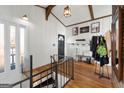 Entryway with wood floors, white walls, black door, and staircase with black metal railing at 405 Miller Rd, Covington, GA 30014