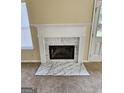 Close-up of the fireplace showcasing the elegant white mantle and marble surround at 3081 Regal Dr, Mcdonough, GA 30253