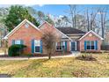Inviting one-story brick home features a cozy bench and lovely landscaping at 418 Crosshaven Way, Mcdonough, GA 30253