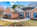 A one-story home with an arched entry door and walkway through a manicured lawn at 418 Crosshaven Way, Mcdonough, GA 30253